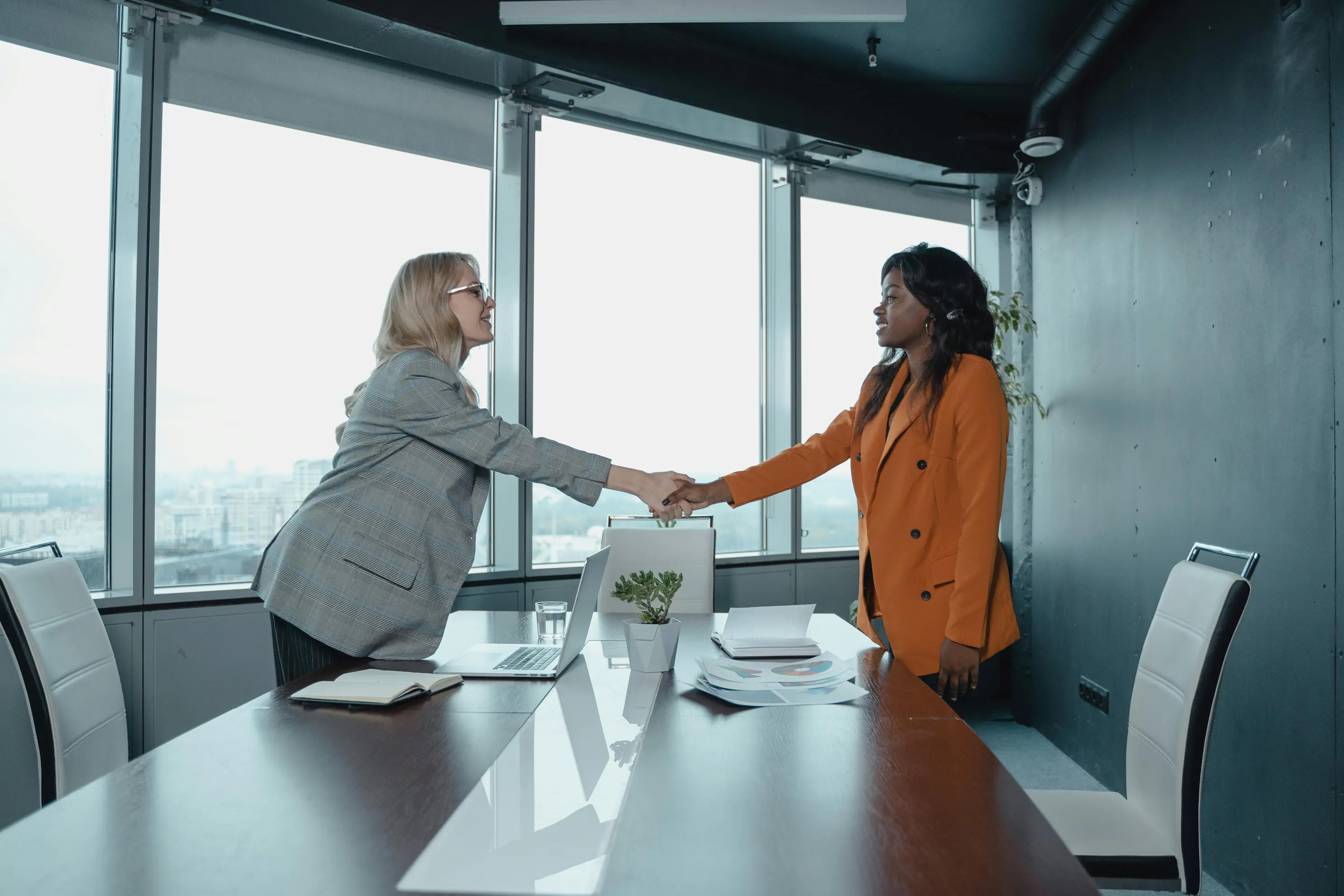 Women shaking hands at a meeting